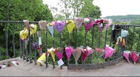 Photo of floral tributes on railings
